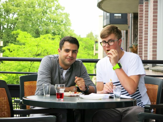 Amir and Gijs enjoying their food outside