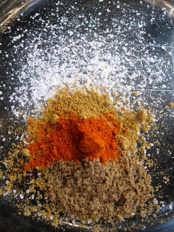 Making the rub for the chicken - salt, cumin, coriander, and cayenne pepper