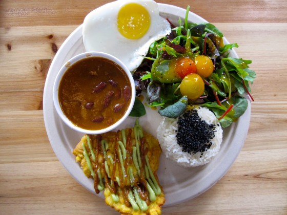 Colombian red bean stew with mango/passion fruit salad, plantain chips, guacamole, rice, spicy salsa, and fried egg