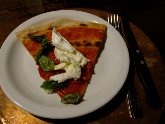 A piece of the margherita with mozzarella