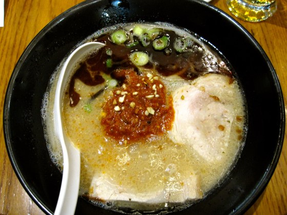 My spicy tonkotsu ramen: tonkotsu broth with homemade noodles topped with Karaka spicy miso paste, pork belly chashu, bean sprouts, sesame kikurage mushrooms, spring onions, roasted cashew nuts, sansho pepper, and fragrant garlic oil